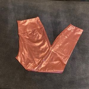 Shiny rose gold Nike tights